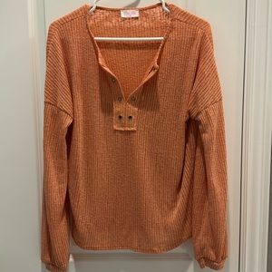Orange knit top by Pink Lily